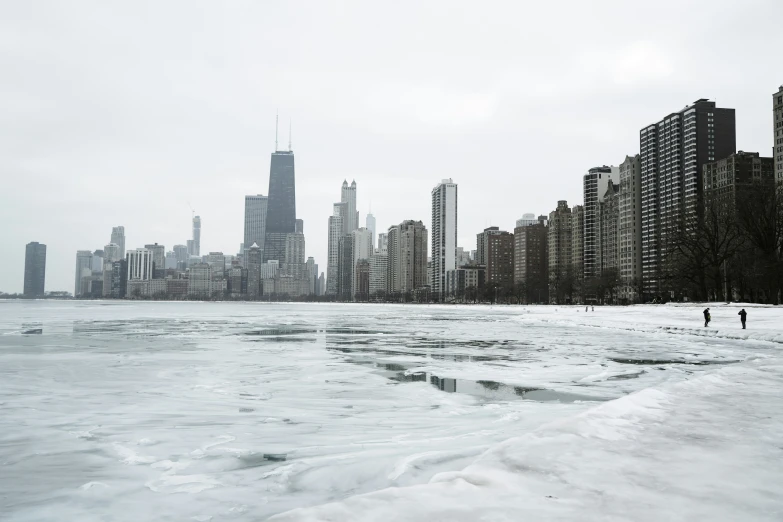 the view of city buildings from across the frozen lake