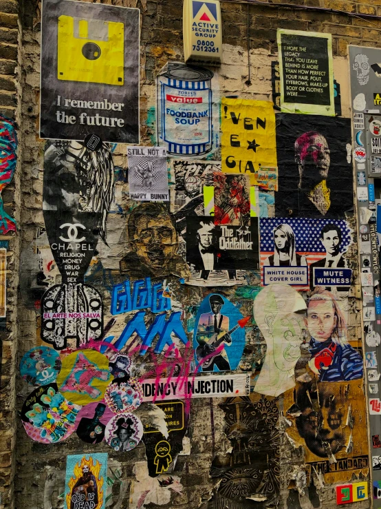 a wall covered in stickers and graffiti