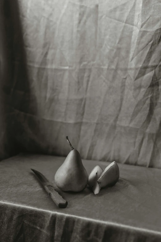 a knife and some pears are on the table