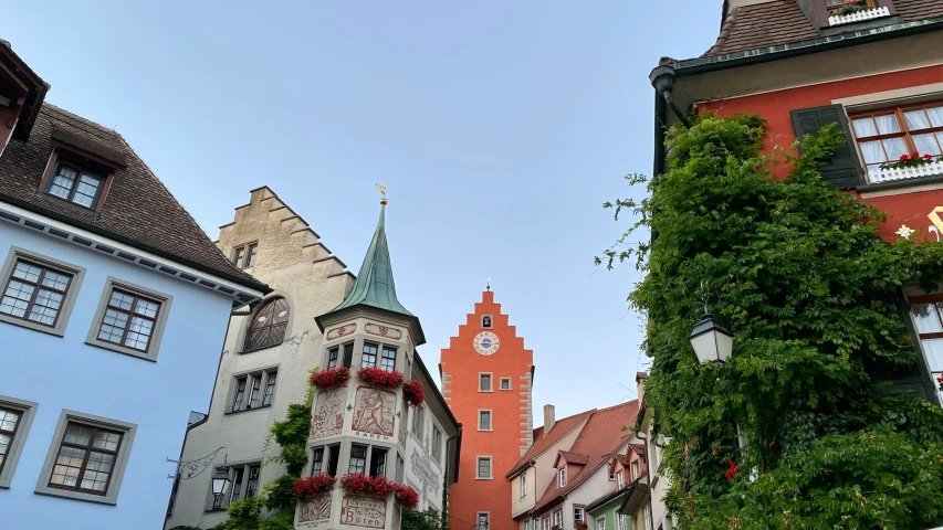 a city street with a tree and building surrounding it