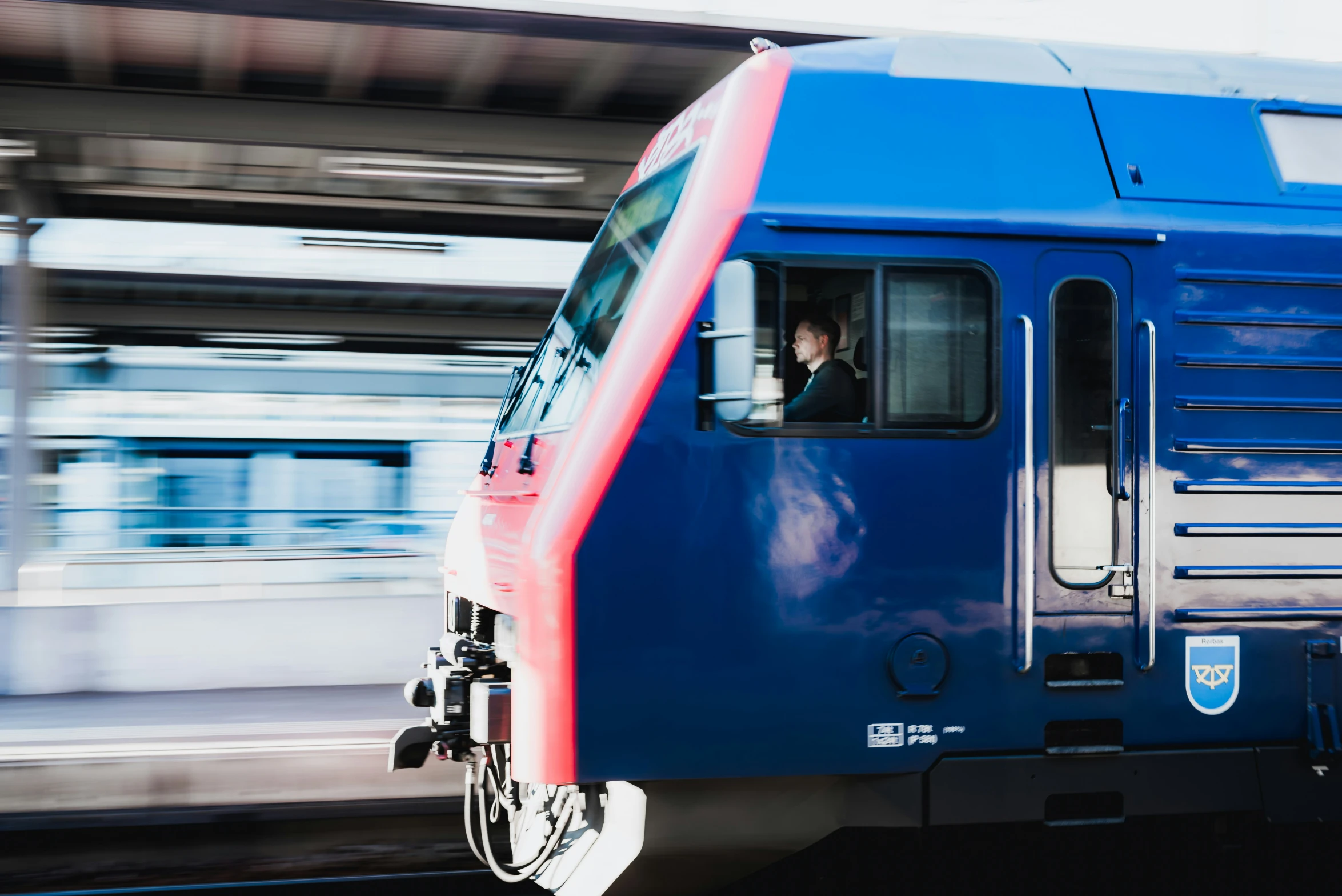 a passenger train is riding past another train