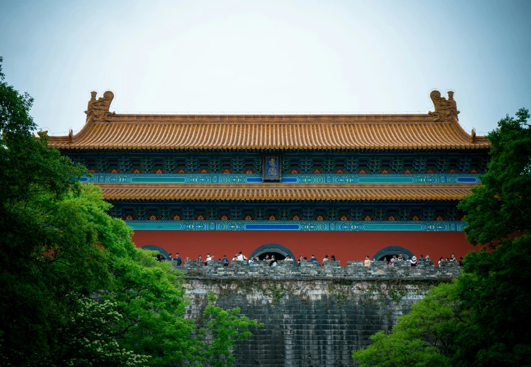 an asian architecture with blue accents and greenery