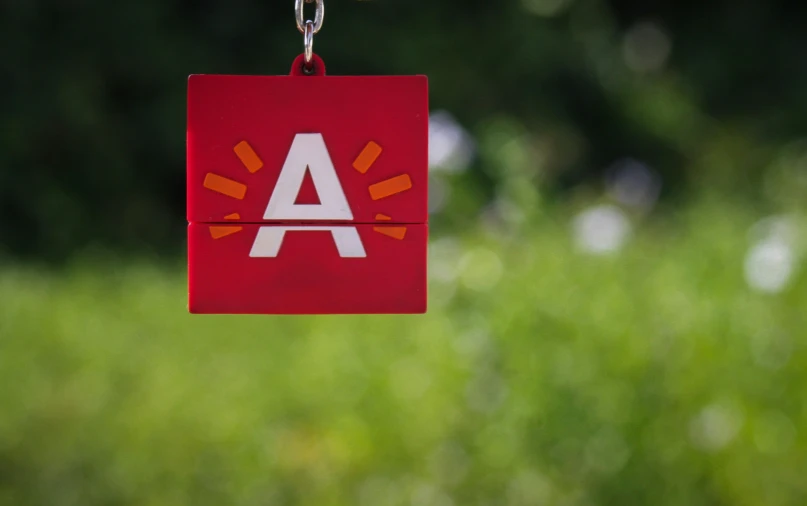 a red paper that has an a symbol on it