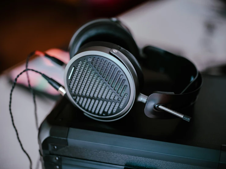 black headphones sitting on top of a desk