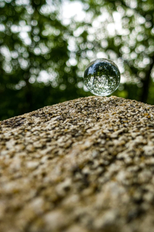 the back end of a rock has a small bubble sitting on it