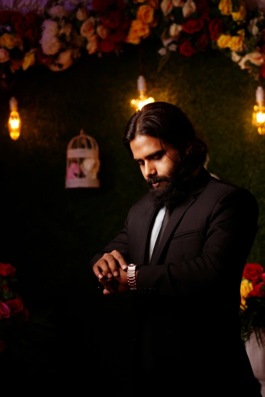 a bearded man in a tuxedo wearing a watch