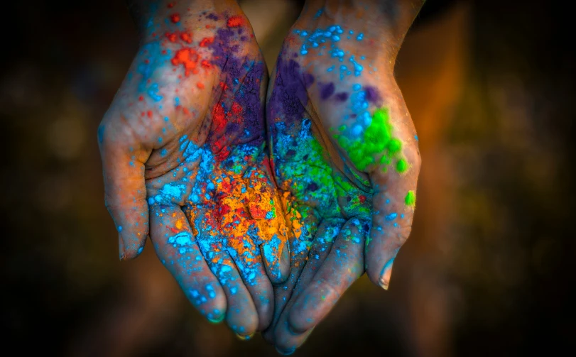 a couple hands that have different colored designs on them