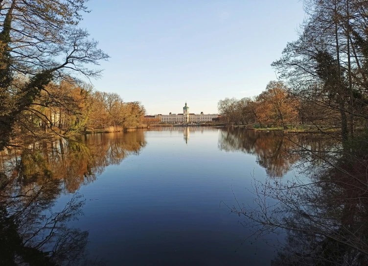 a river surrounded by trees and a light house