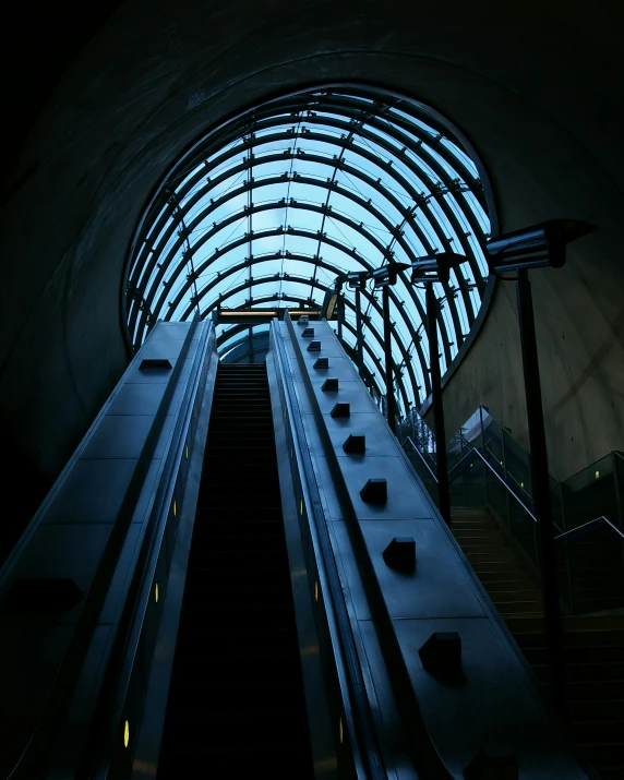 an escalator going through a train tunnel