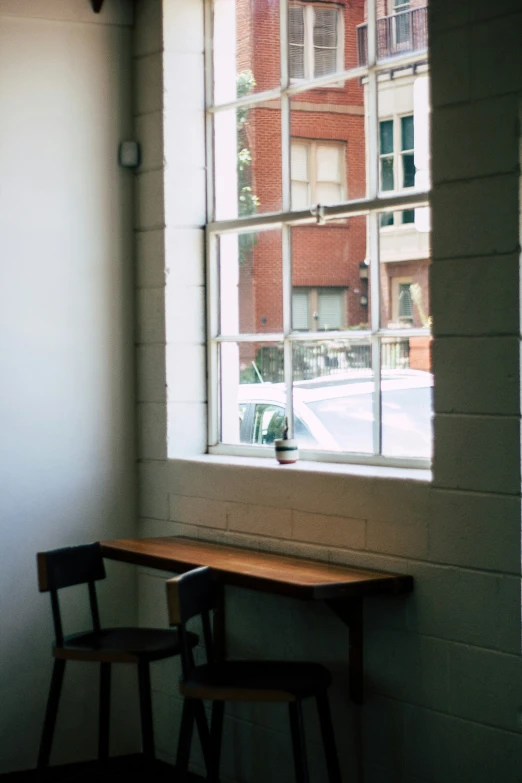 two chairs and a table in front of a window