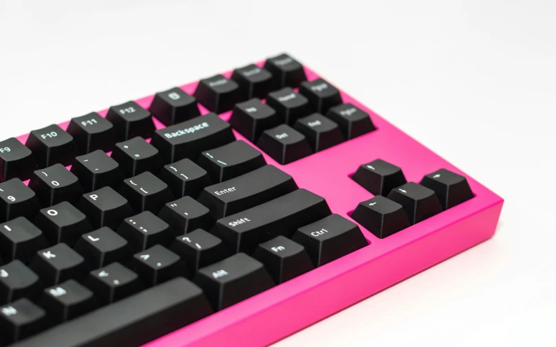 a pink and black keyboard is in an image