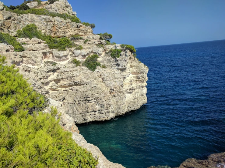 the cliff on the side of the water is steep and empty