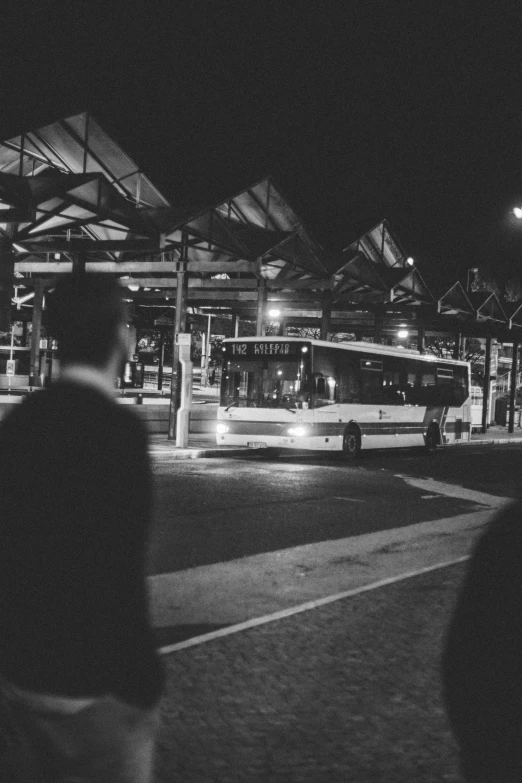 black and white pograph of passengers waiting at a station