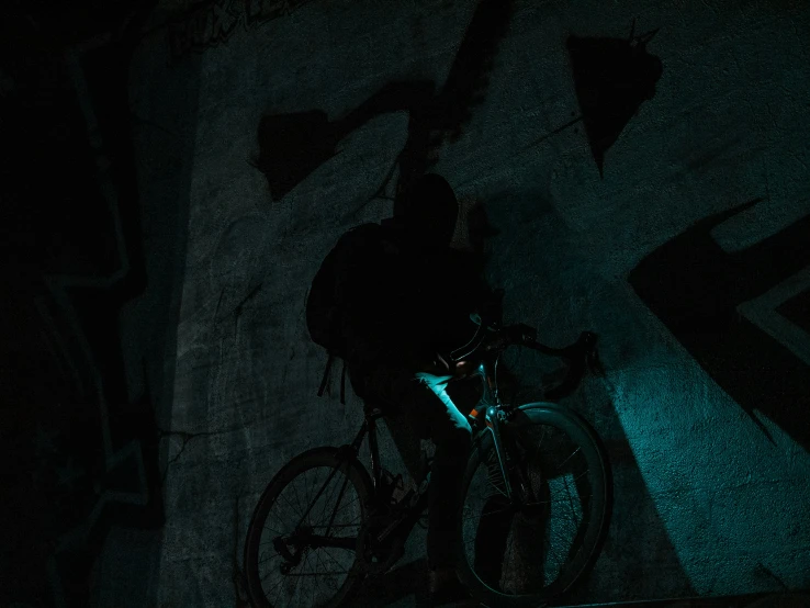 a person is riding a bicycle in the dark