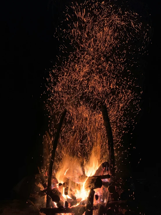 bonfire in the dark during the evening with many fireworks