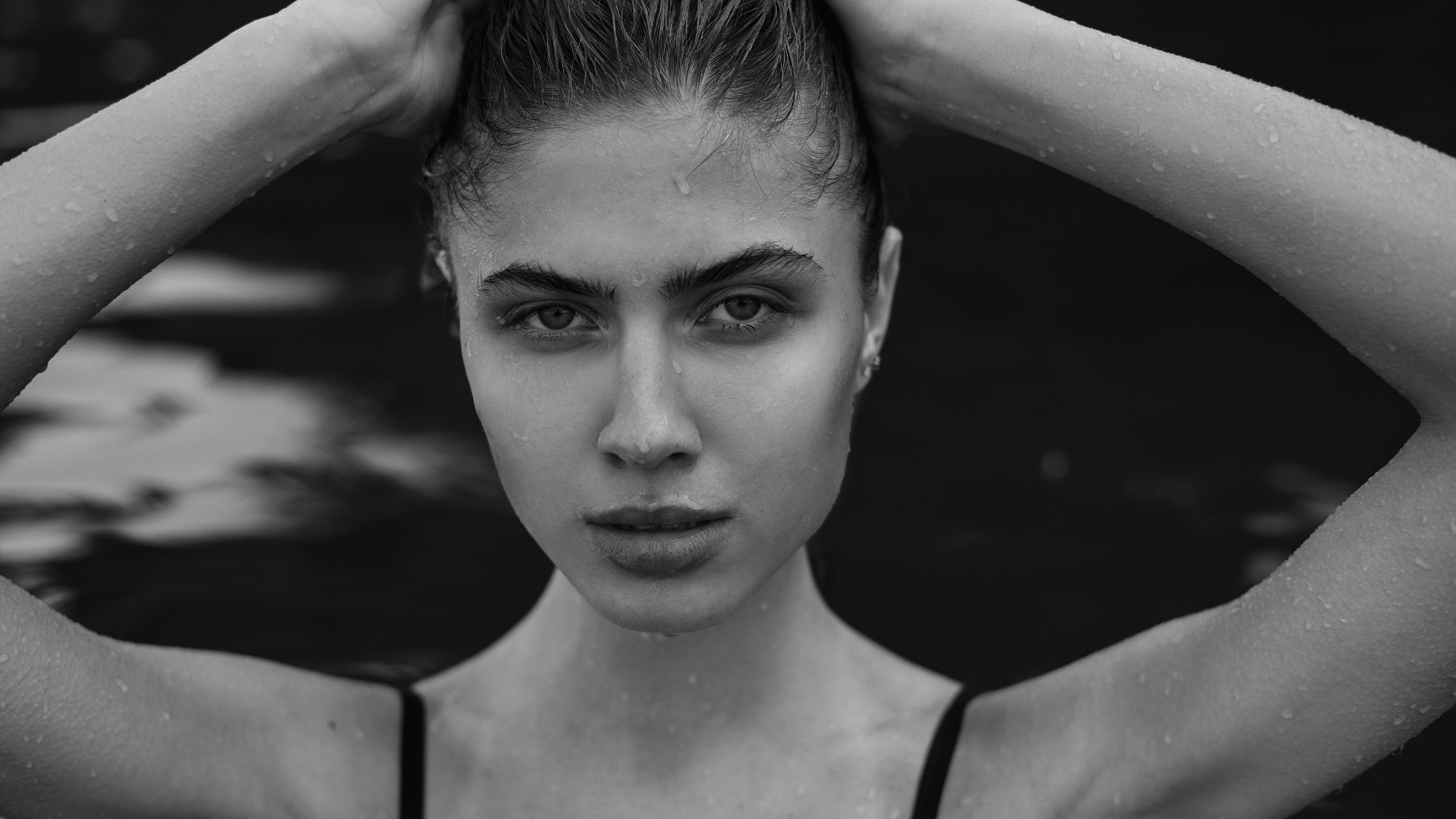 black and white po of a woman with her hand on her head