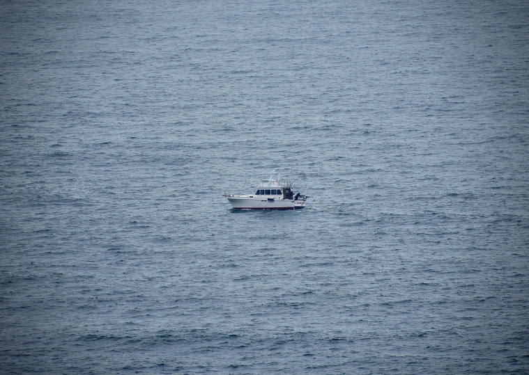 a boat in the water with a lone person on top