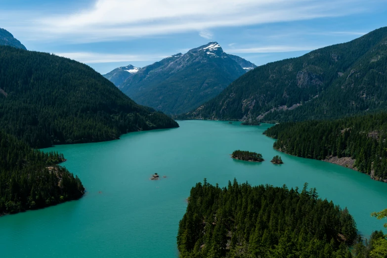 the mountains and trees are surrounding a lake