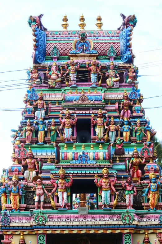 a temple with a large multicolored tower on the top