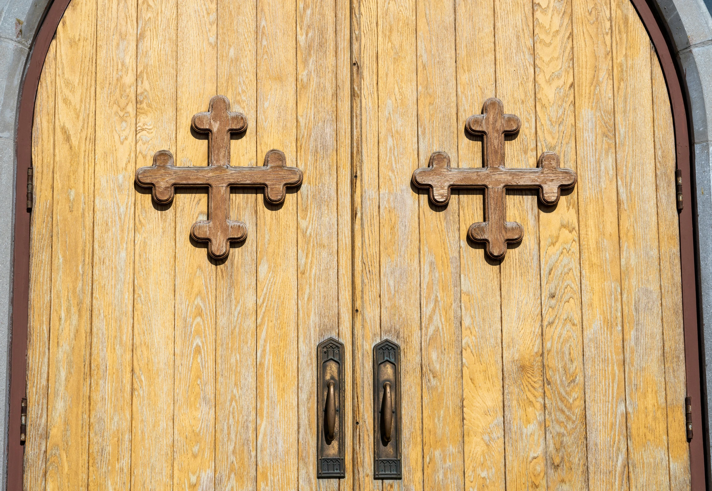 an old church with the door closed and two crosses drawn