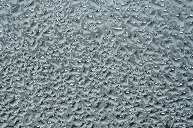 several droplets of water on a wet glass surface