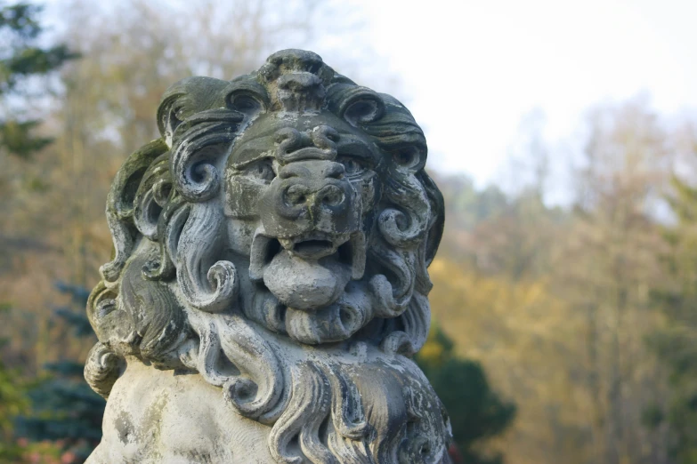 an animal statue is standing out in the middle of a garden