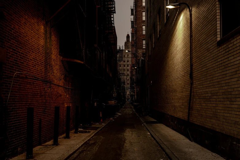 street lighting shining down an alley way next to tall buildings