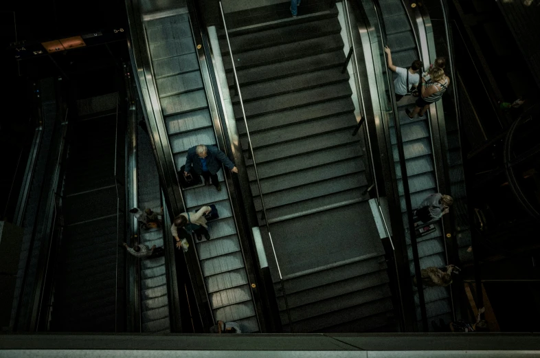 an escalator with two people standing on it