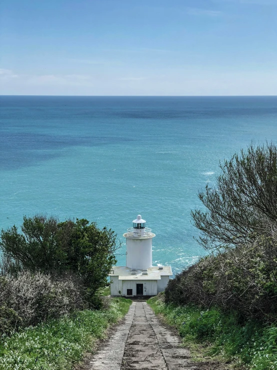 a light house that is in the grass