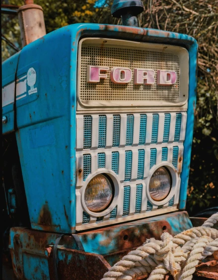 a blue antique radio that reads ford next to some ropes