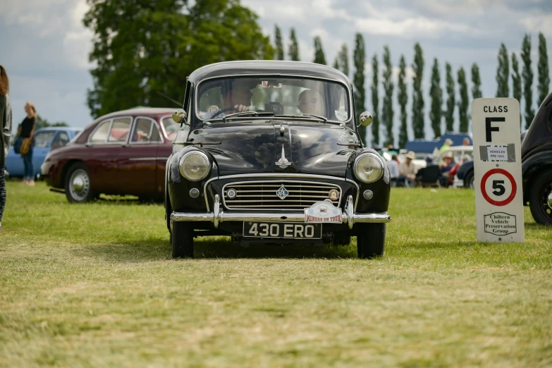 vintage car on display at event in grassy area