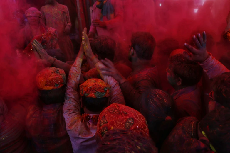 a large crowd of people painted in red and purple