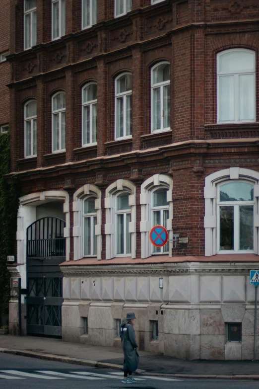 a blue street sign hanging from the side of a building