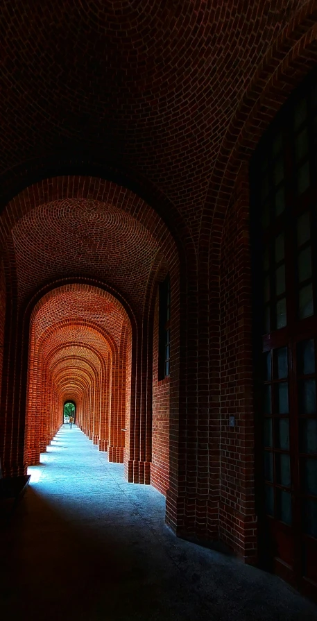 a tunnel under the lights is dark and empty