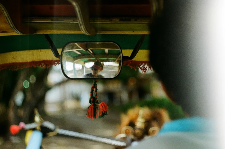 the reflection of people in the rearview mirror