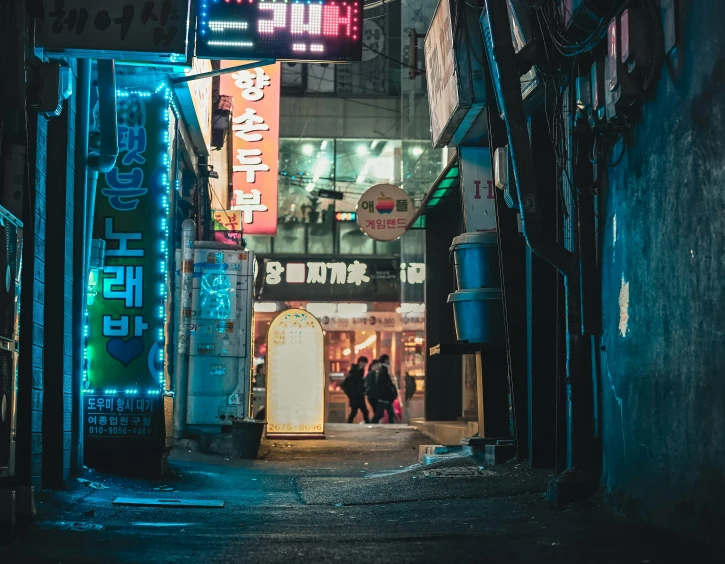 a city street at night with illuminated signs in japanese