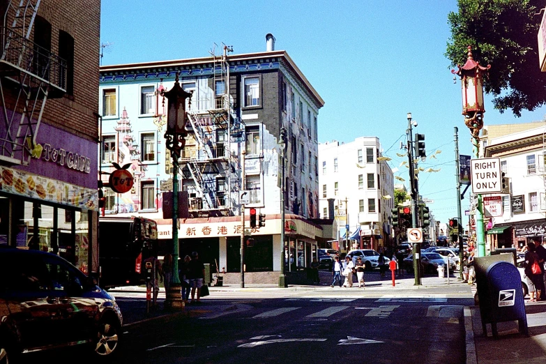 a street with buildings, cars, a bicycle and other vehicles in it