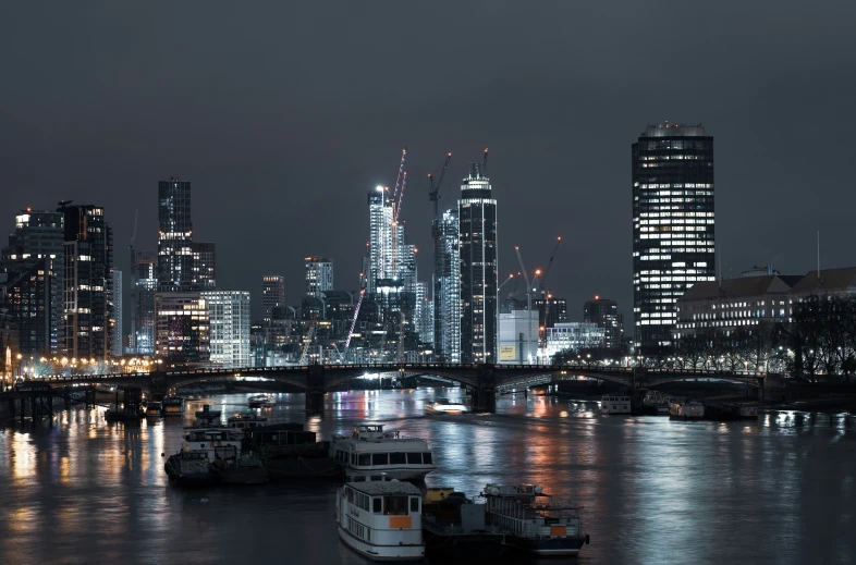 the skyline at night as seen from across a river