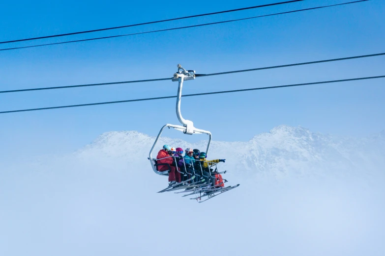 a ski lift filled with people on top of it