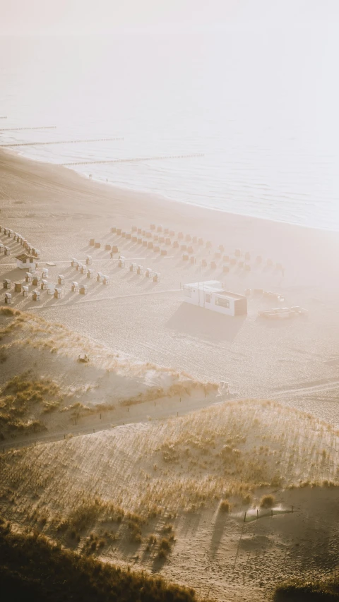 a truck on a sandy beach near water