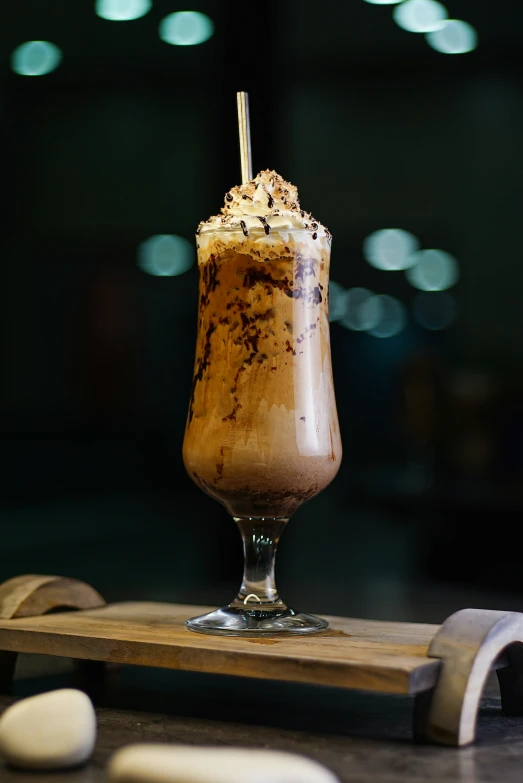 a drink on top of a table surrounded by white pills