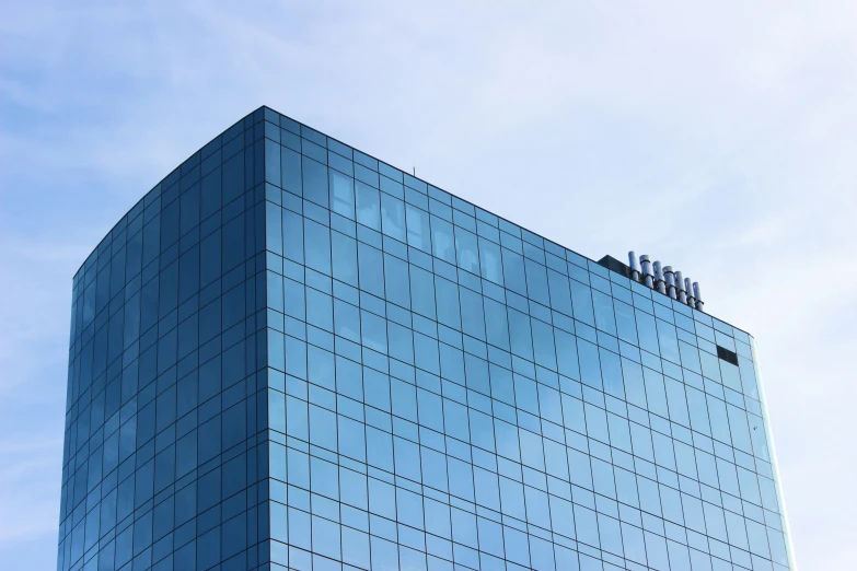 the corner of the building has a blue glass wall