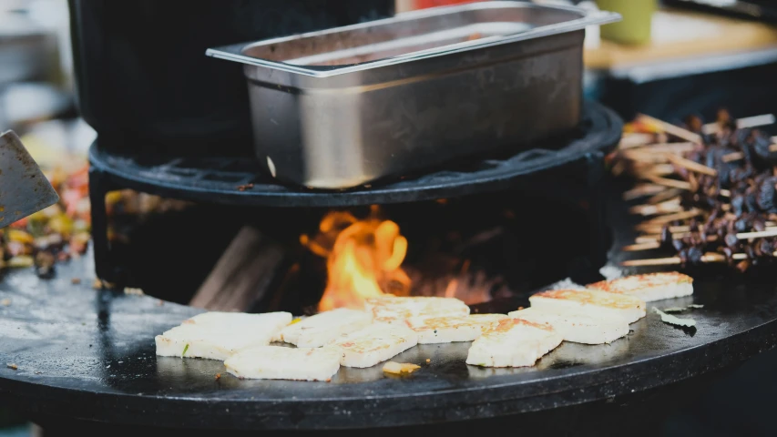 many sticks being used to cook soing outside