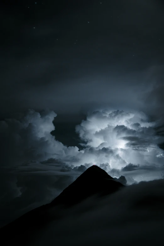 a dark cloud over a hill with lightning bolt