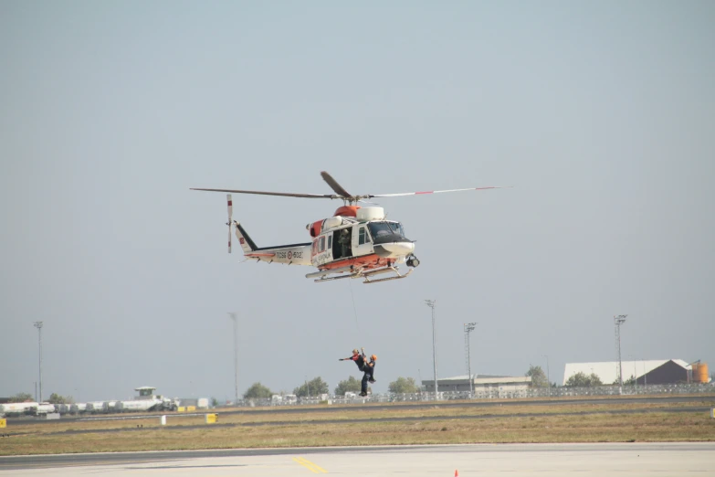 a helicopter is taking off from an airport runway