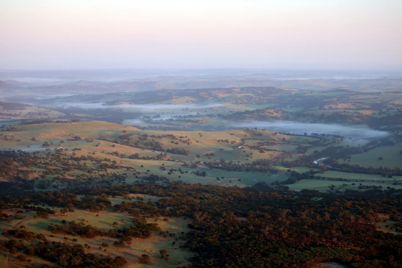 an aerial view of a lake and land