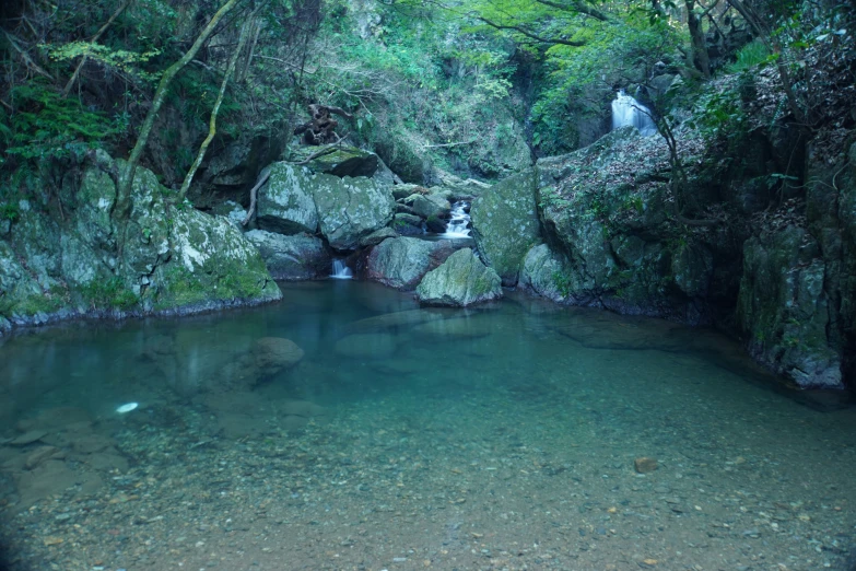 a pool of water surrounded by large rocks