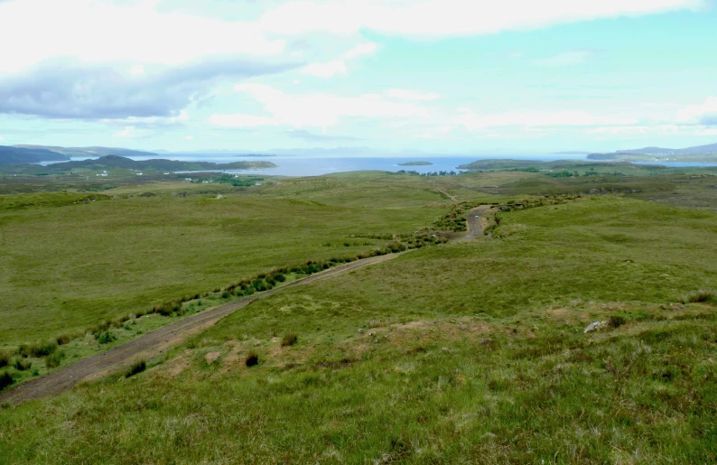 a winding road near a grassy plain