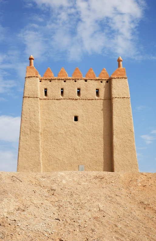 a big building sitting on top of a dirt hill