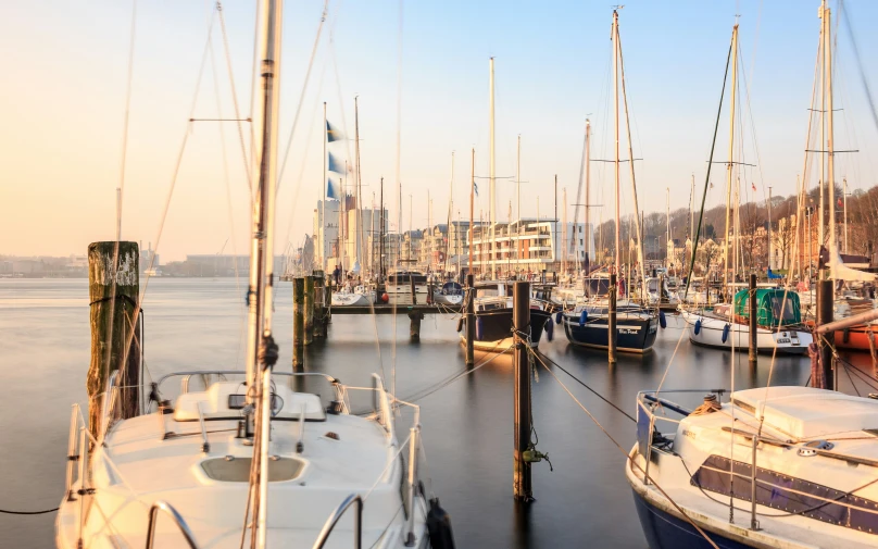 some very pretty boats in the water by some buildings